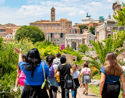Families exploring the Roman Forum with a guide during the Gladiator Tour in Rome.