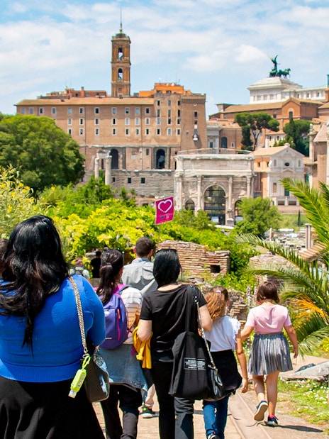 Families exploring the Roman Forum with a guide during the Gladiator Tour in Rome.