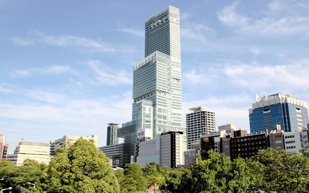 Abeno Harukas skyscraper towering over Osaka cityscape.