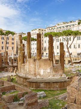 Ancient ruins of Largo di Torre Argentina in Rome with surrounding buildings.