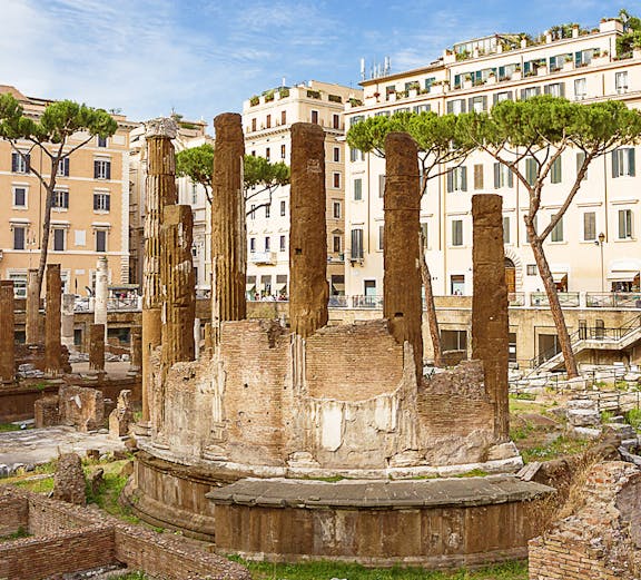 Ancient ruins of Largo di Torre Argentina in Rome with surrounding buildings.