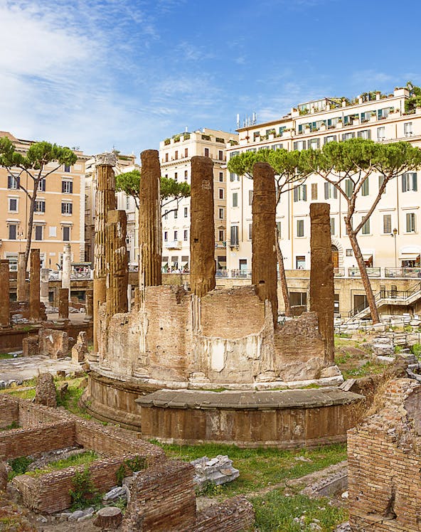 Ancient ruins of Largo di Torre Argentina in Rome with surrounding buildings.