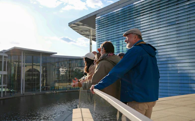 Tour group overlooking the river near the Reichstag and Government District in Berlin.