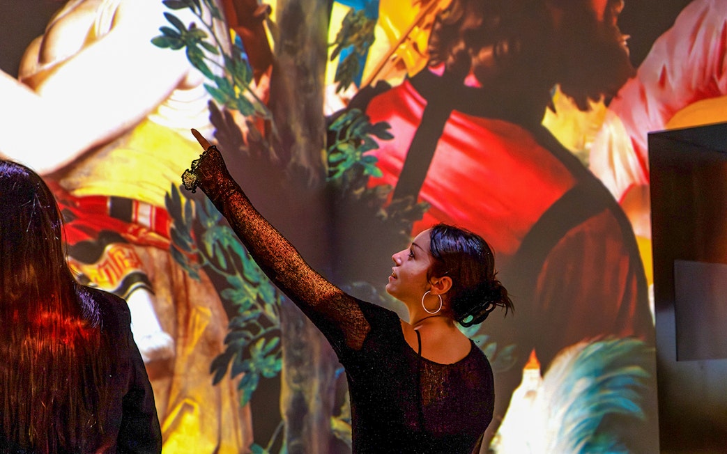 Tourists viewing artwork at 'From Vermeer to Van Gogh, Dutch Masters' exhibition.