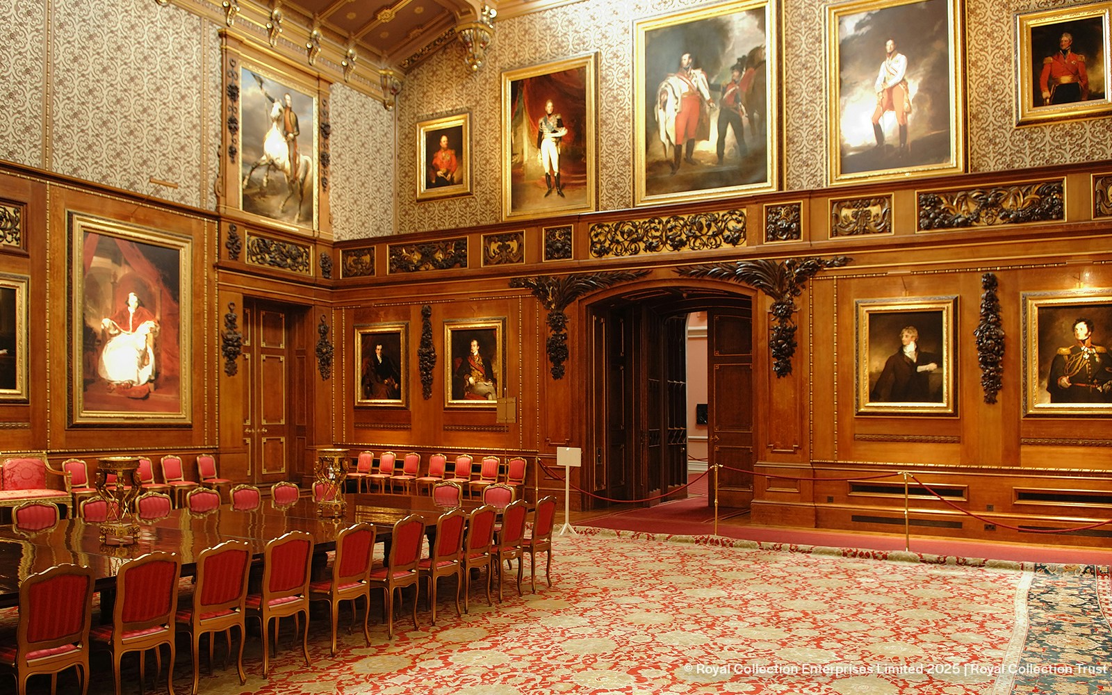 Windsor Castle interior with ornate wood paneling and historical portraits.