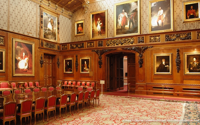 Windsor Castle interior with ornate wood paneling and historical portraits.