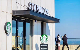 Starbucks entrance at Aegibong Observatory, DMZ, South Korea with visitors looking out.