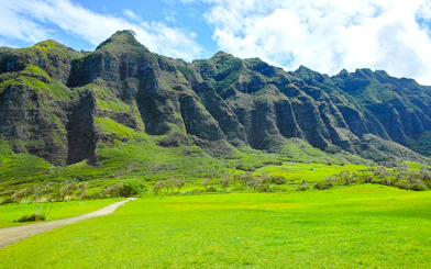Kualoa Ranch lush green valley with towering mountains in Hawaii.