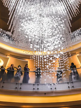 Guests on balcony under chandelier at Dubai Opera.