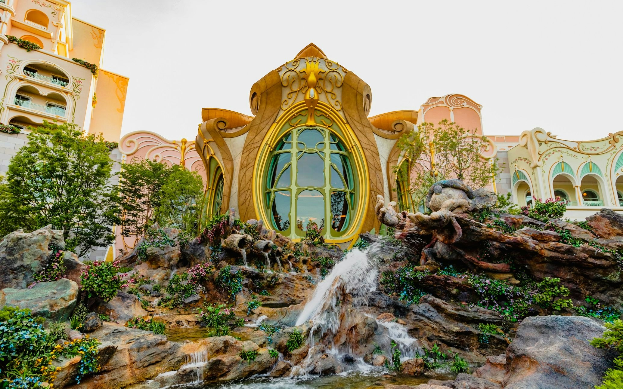 Fantasy Springs entrance with waterfall and character statue at Tokyo DisneySea, Urayasu, Japan.
