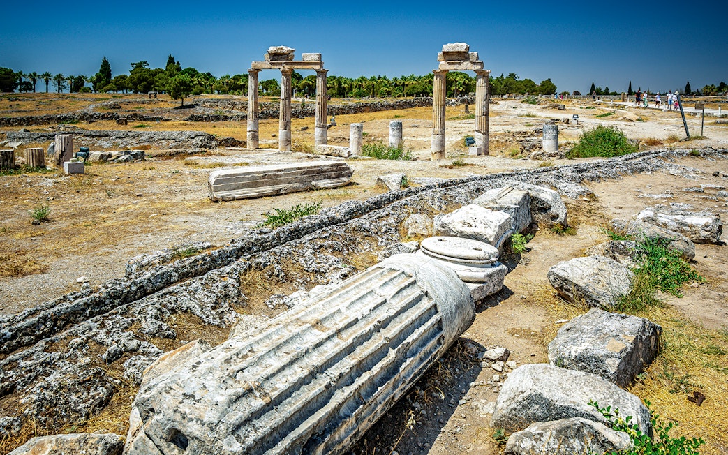 Hierapolis ruins with ancient columns and stone structures in Pamukkale, Turkey.