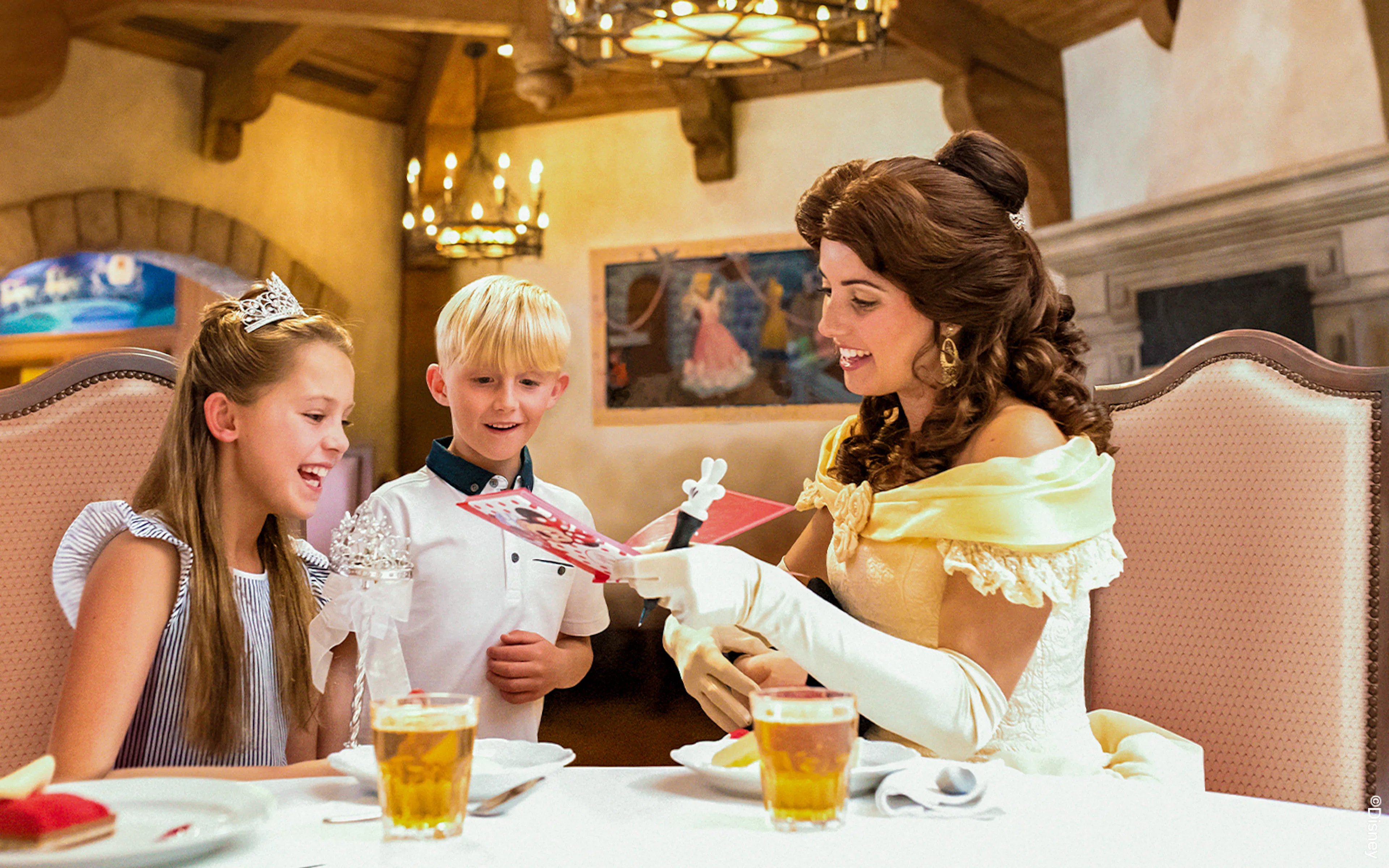 Children meeting a character at Auberge de Cendrillon, Disneyland Paris.