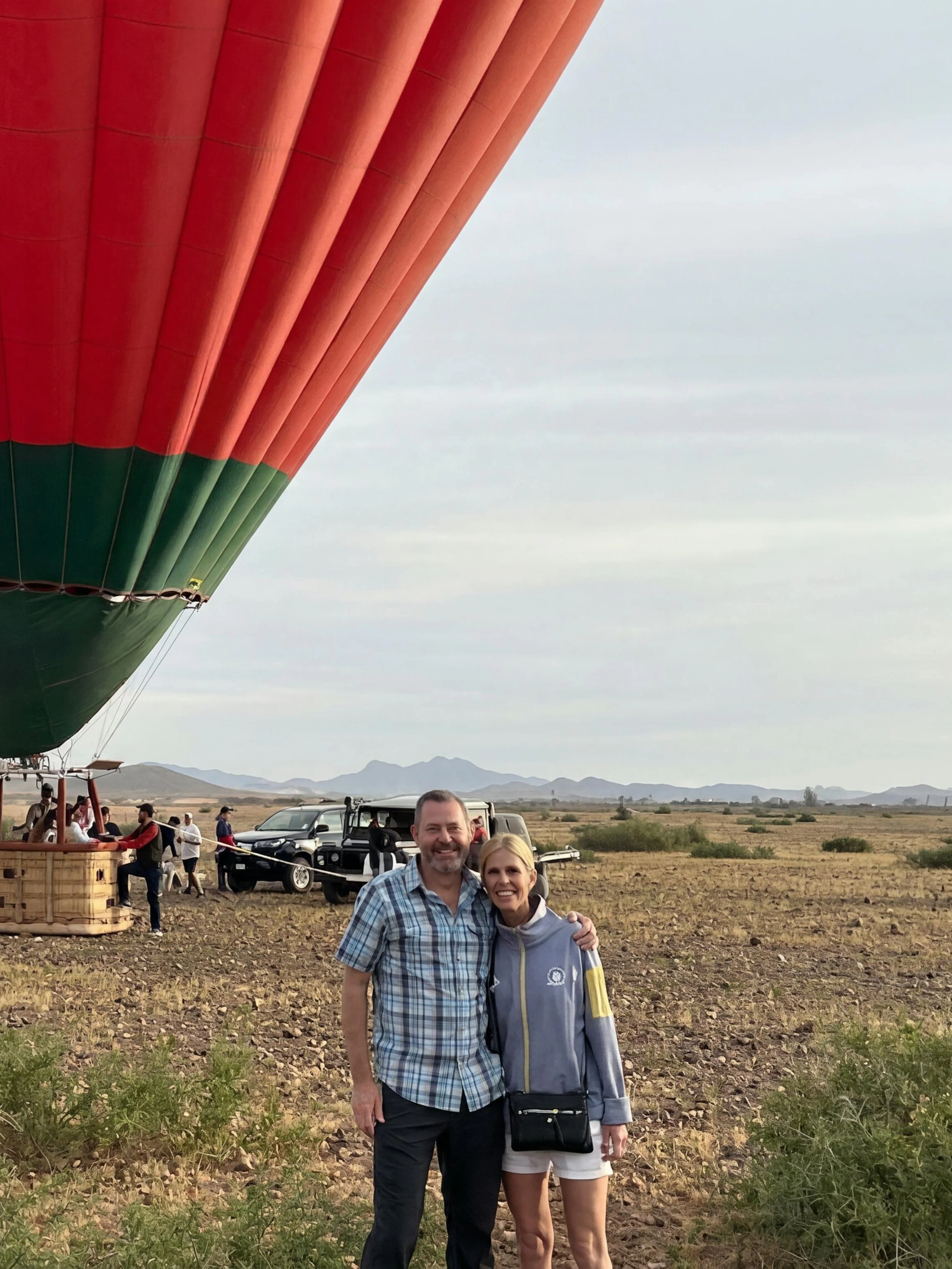 Hot air balloon preparing for sunrise flight in Marrakech desert landscape.