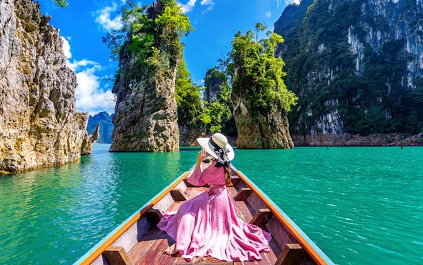 Boat ride through limestone cliffs in Phuket, Thailand.
