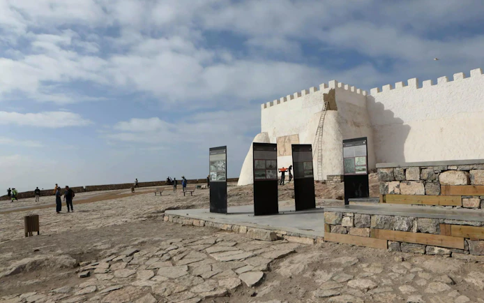 Kasbah of Agadir Oufella with tourists exploring historical site in Agadir, Morocco.