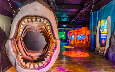 Cave of the Ancients exhibit entrance at SEA LIFE Melbourne with shark jaw display.