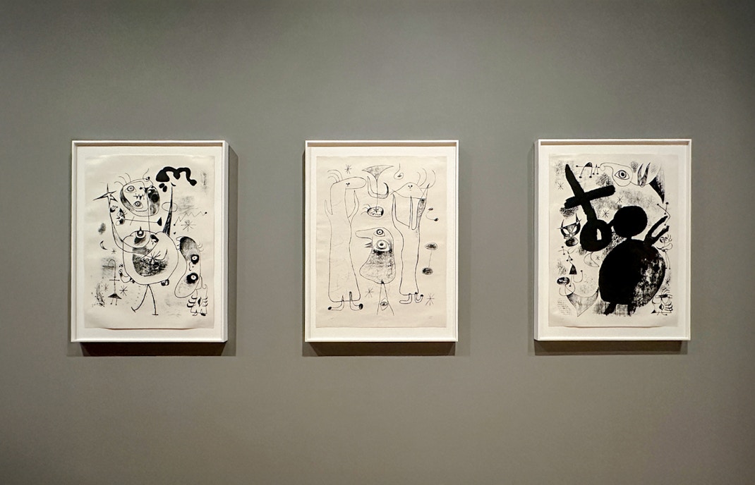 Modern art installation at MoMA, New York City, featuring abstract sculptures and vibrant paintings.