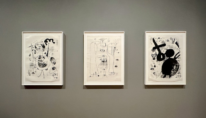 Modern art installation at MoMA, New York City, featuring abstract sculptures and vibrant paintings.