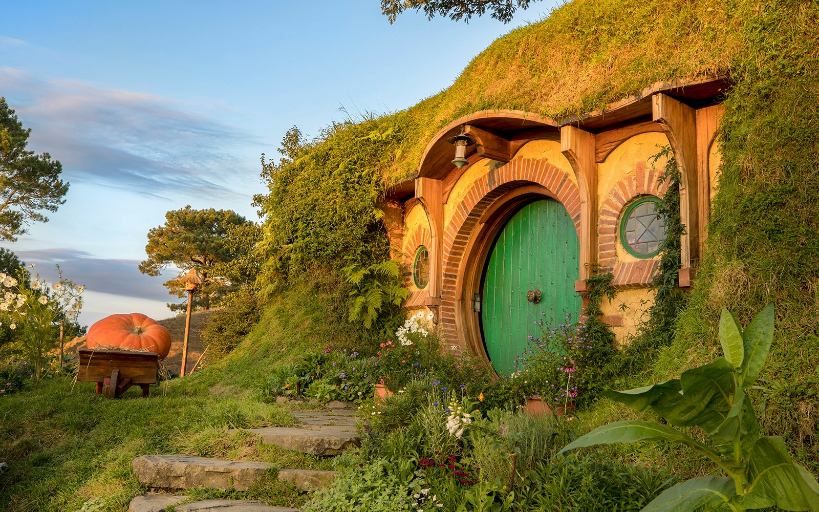 Hobbiton Movie Set with round green door and garden, Auckland tour.