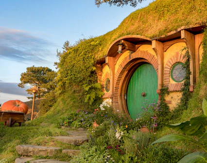 Hobbiton Movie Set with round green door and garden, Auckland tour.