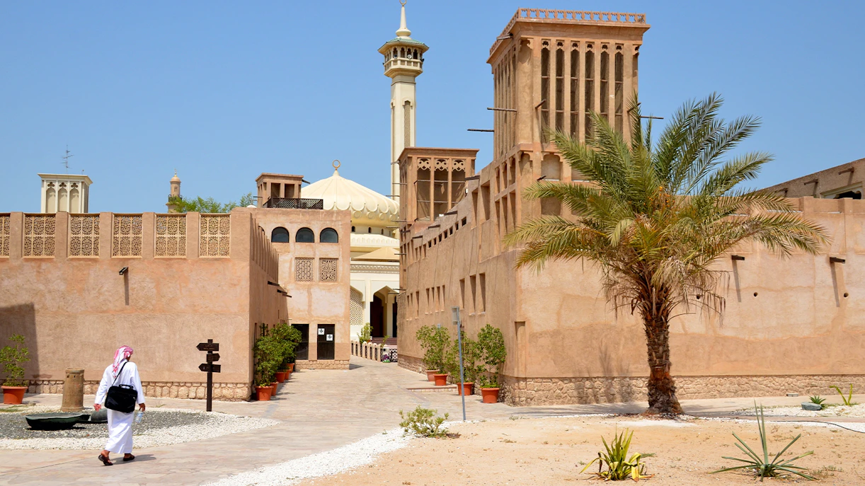 Al Fahidi Historical District with traditional wind towers and a mosque in Dubai.