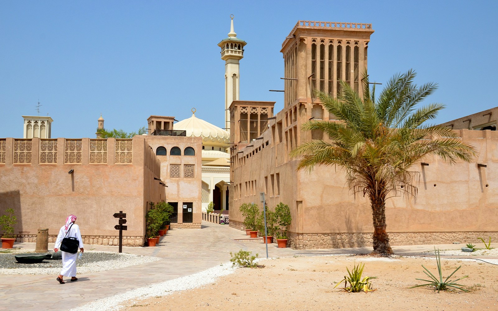 Al Fahidi Historical District with traditional wind towers and a mosque in Dubai.