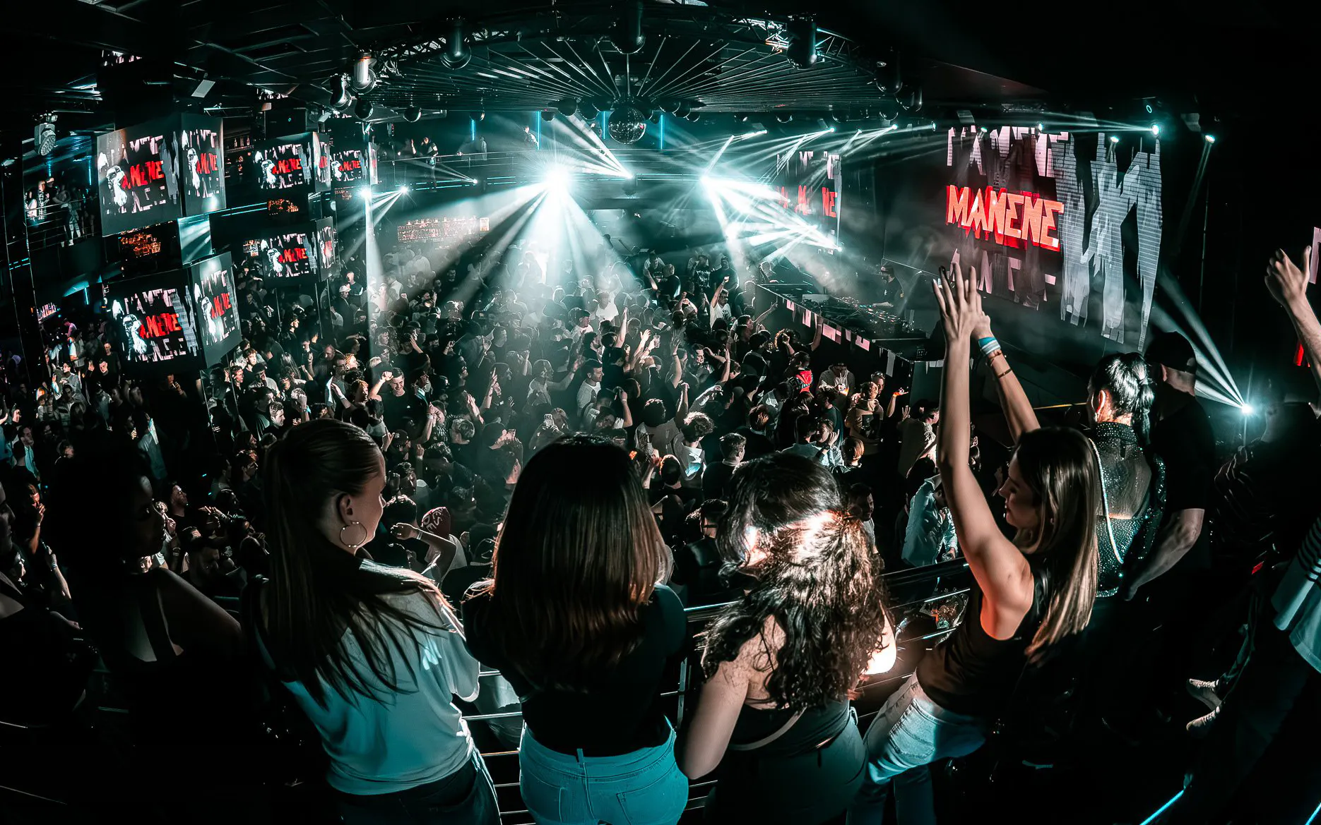 Crowded dance floor at Epic Club Prague with DJ performing.