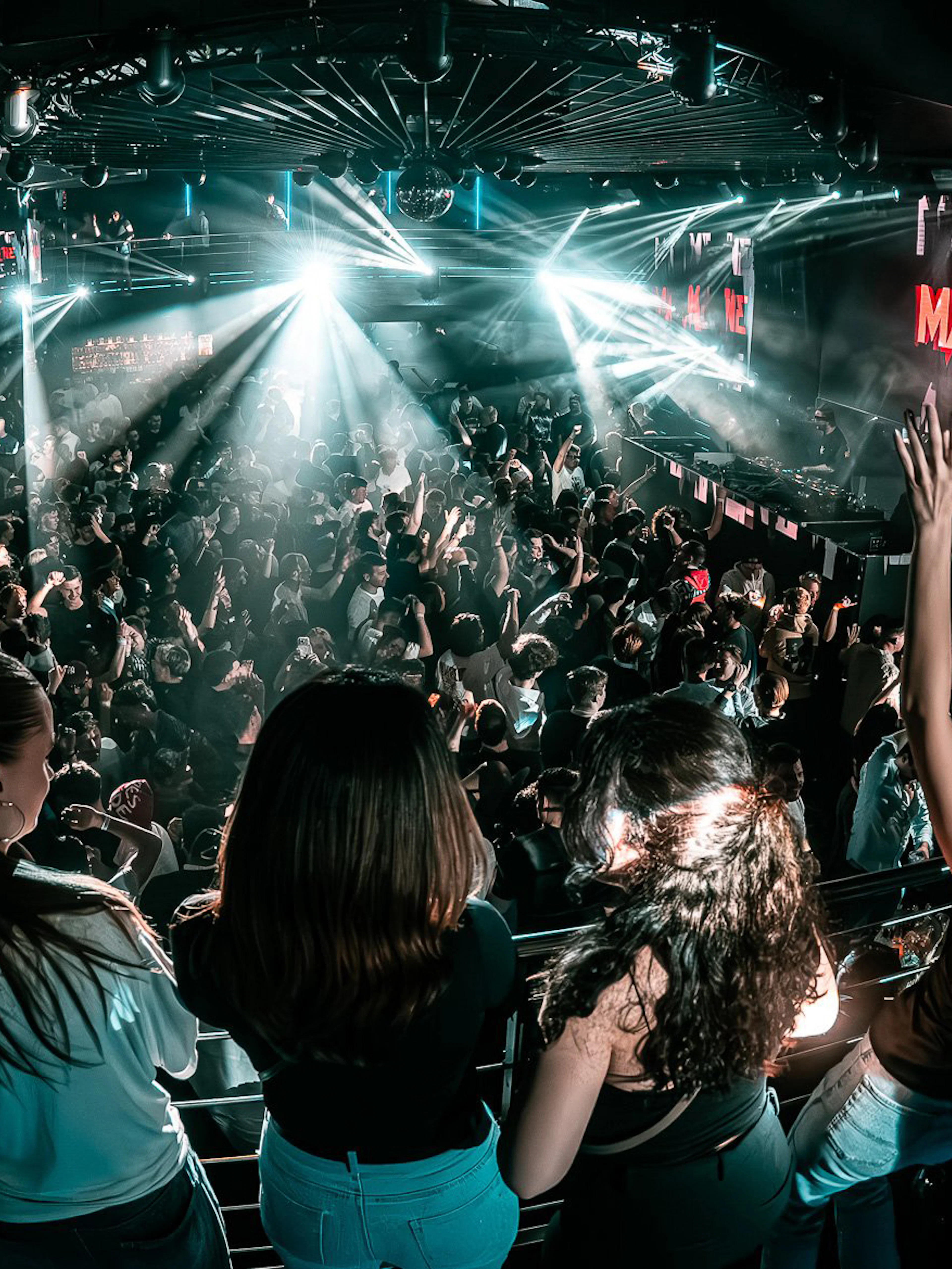 Crowded dance floor at Epic Club Prague with DJ performing.