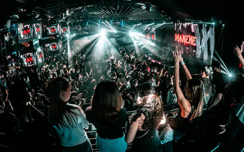 Crowded dance floor at Epic Club Prague with DJ performing.