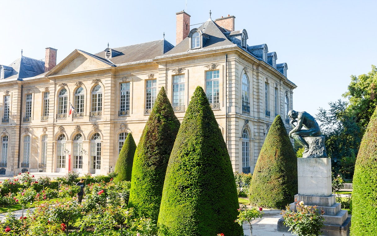Rodin Museum garden with sculpture and historic building in Paris.
