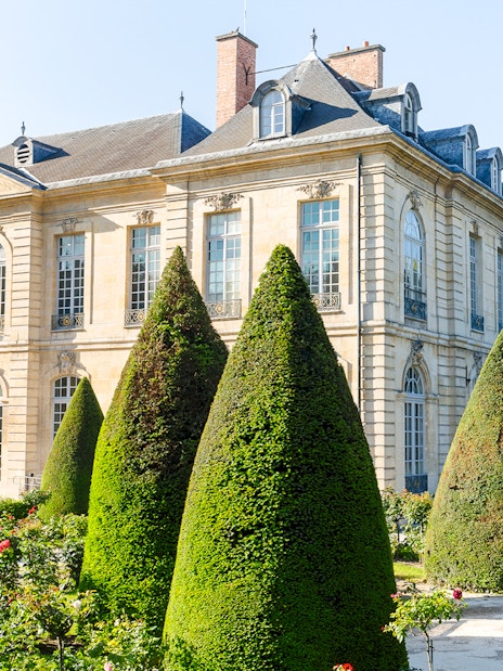 Rodin Museum garden with sculpture and historic building in Paris.