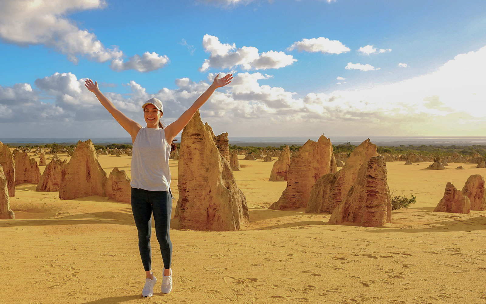 Pinnacles Desert with person enjoying limestone formations on 1-Day Guided Tour from Perth.