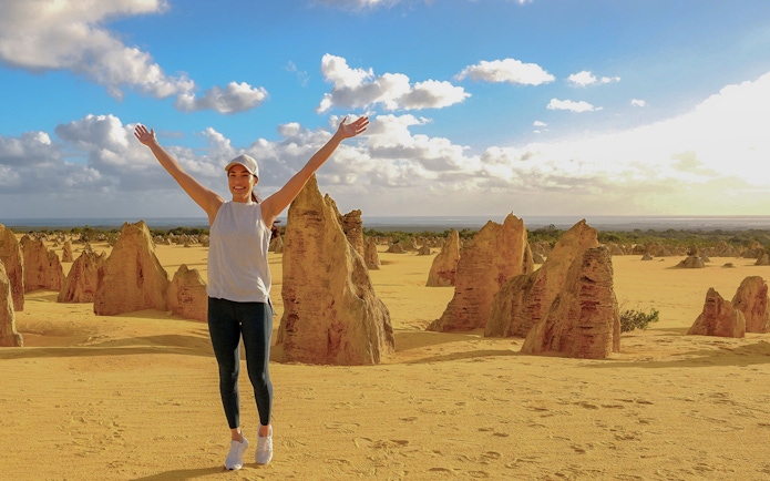 Pinnacles Desert with person enjoying limestone formations on 1-Day Guided Tour from Perth.
