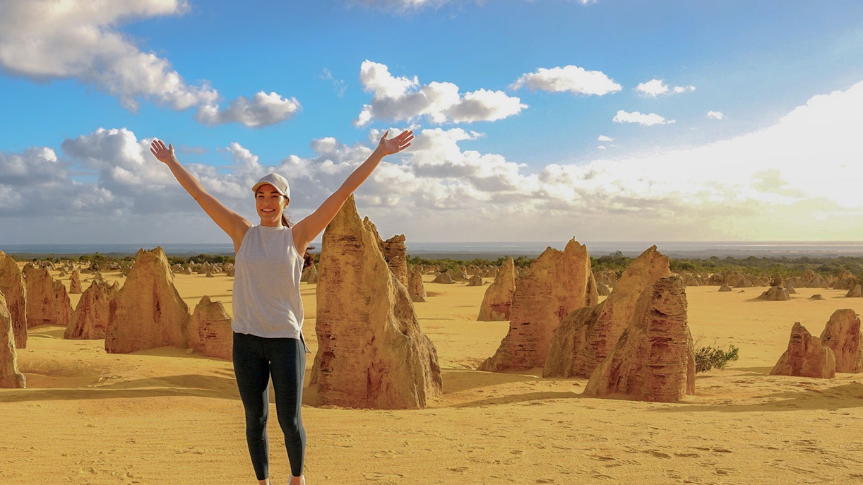 Pinnacles Desert with person enjoying limestone formations on 1-Day Guided Tour from Perth.
