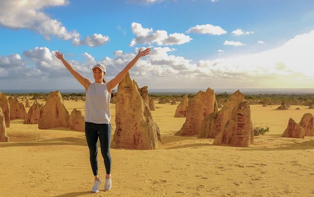 Pinnacles Desert with person enjoying limestone formations on 1-Day Guided Tour from Perth.