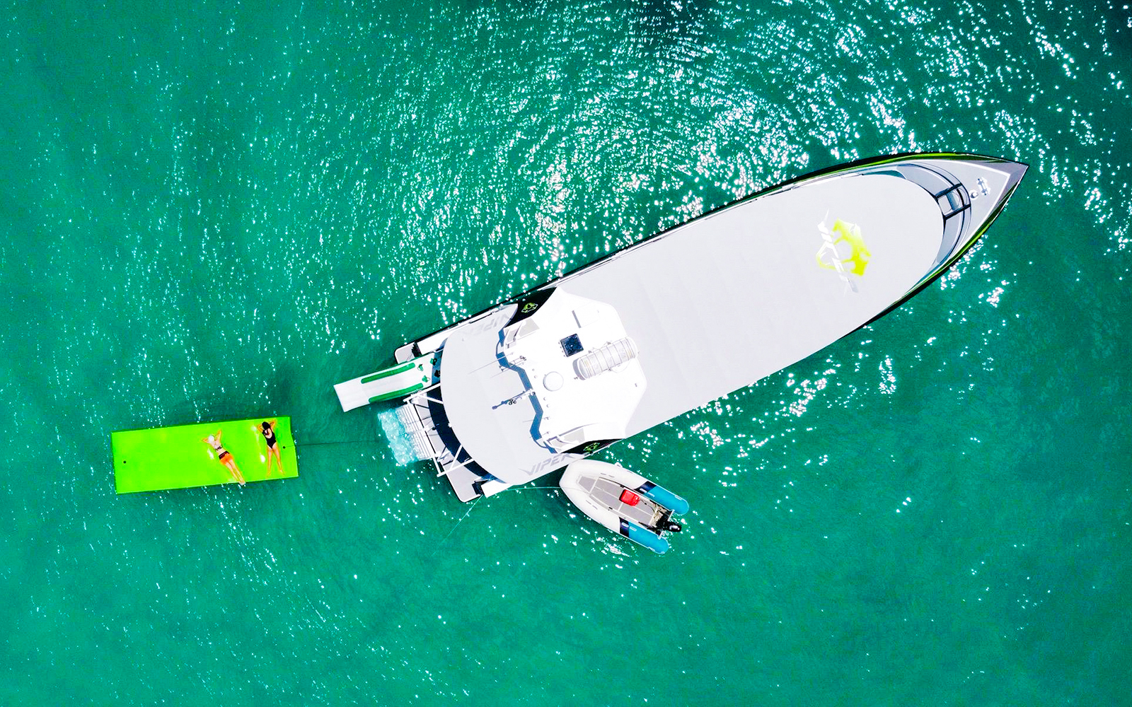 Aerial view of tourists on a boat and floating mat in Whitsundays.