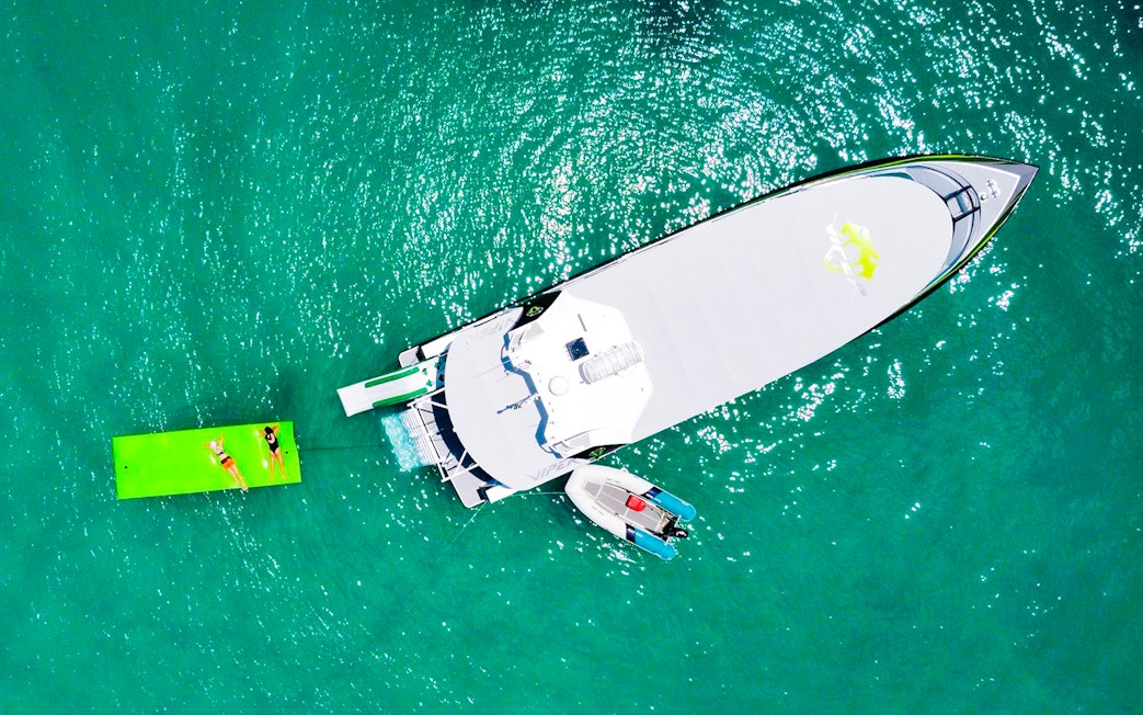 Aerial view of tourists on a boat and floating mat in Whitsundays.