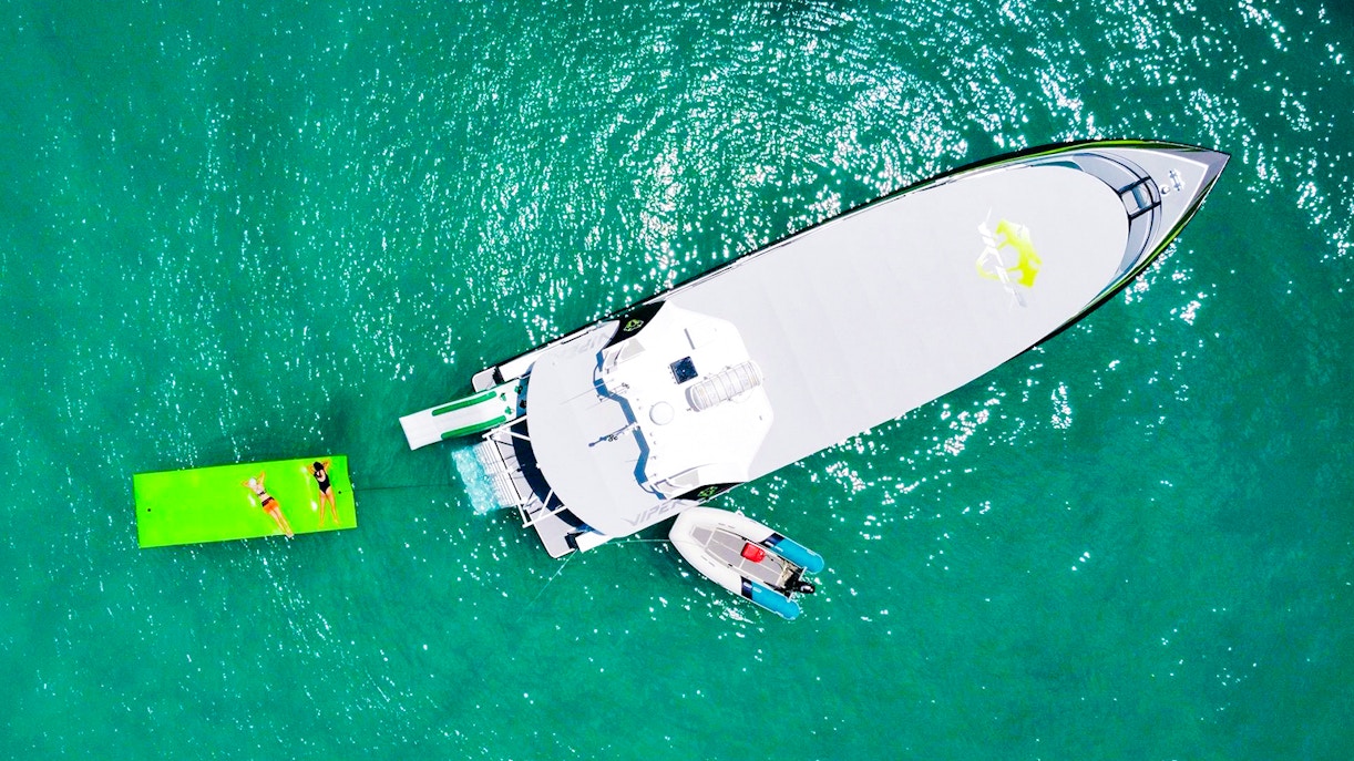 Aerial view of tourists on a boat and floating mat in Whitsundays.