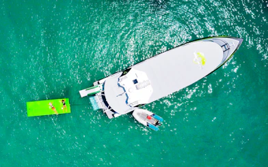 Aerial view of tourists on a boat and floating mat in Whitsundays.