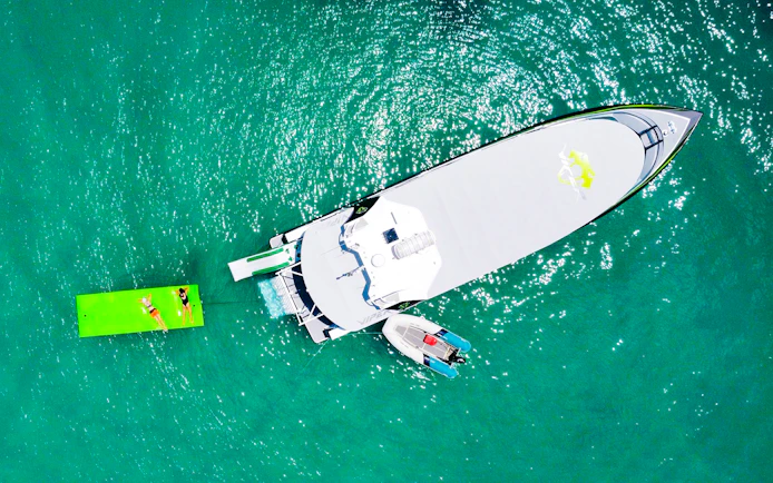 Aerial view of tourists on a boat and floating mat in Whitsundays.