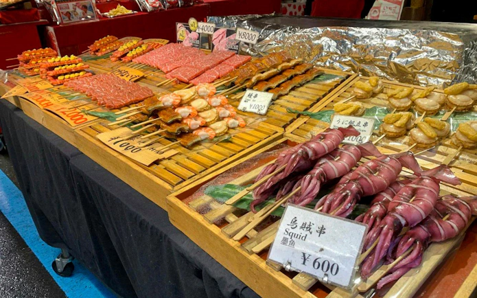 Seafood skewers including squid and scallops at Tsukiji Fish Market, Tokyo.