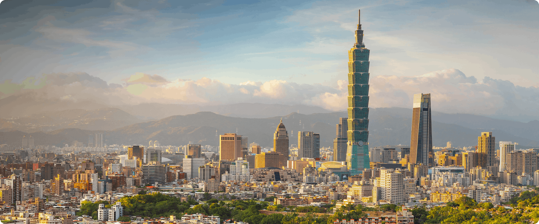 Taipei skyline with Taipei 101 and surrounding buildings at sunset.