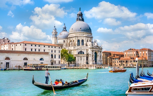 Gondola ride on the Grand Canal with Santa Maria della Salute in Venice, Italy.