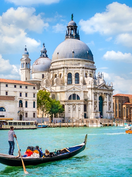 Gondola ride on the Grand Canal with Santa Maria della Salute in Venice, Italy.