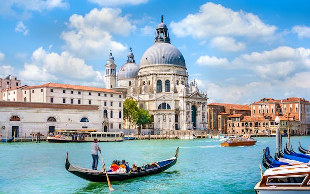 Gondola ride on the Grand Canal with Santa Maria della Salute in Venice, Italy.