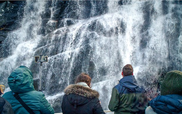 Guests enjoying Scenic view of Mostraumen during Mostraumen Fjord Cruise from Bergen