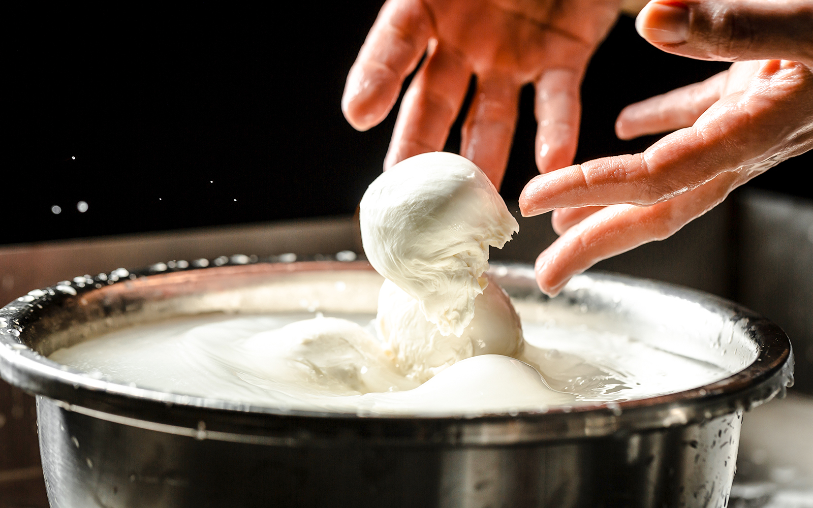 Chef crafting mozzarella cheese at Cheese Museum in Paris.