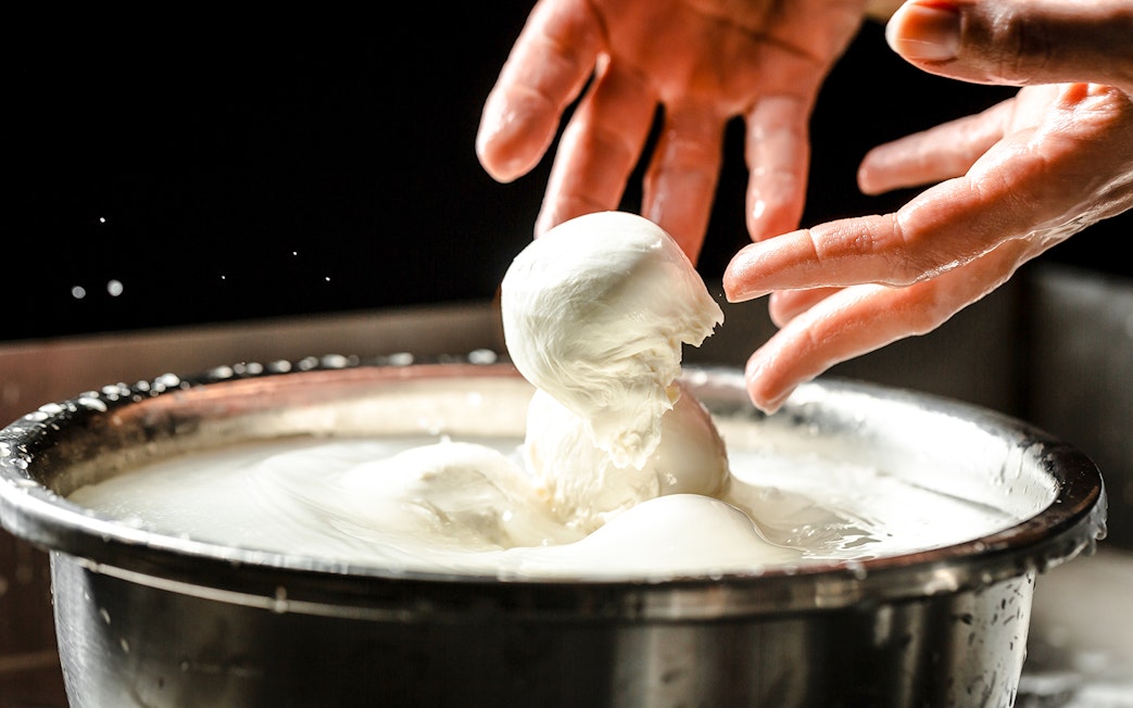 Chef crafting mozzarella cheese at Cheese Museum in Paris.
