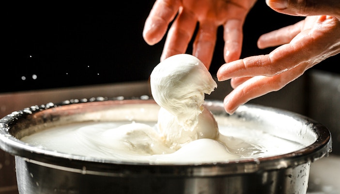 Chef crafting mozzarella cheese at Cheese Museum in Paris.