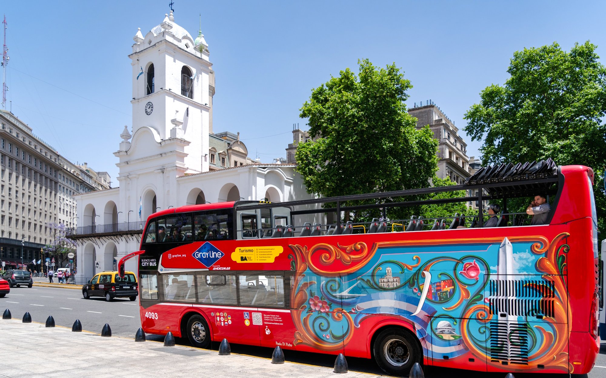 Hop-on hop-off bus near Cabildo of Buenos Aires on a sunny day.